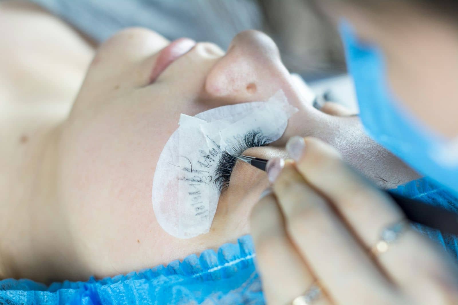 Client with under-eye pads during a lash treatment